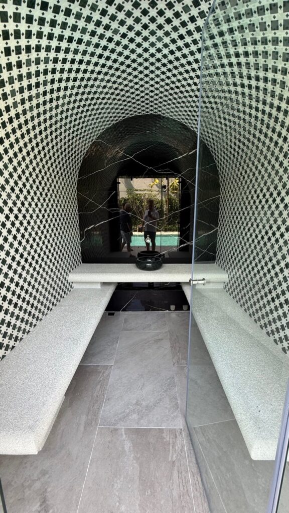 Aggregate-finished seats inside the steam room at Laguna Homes