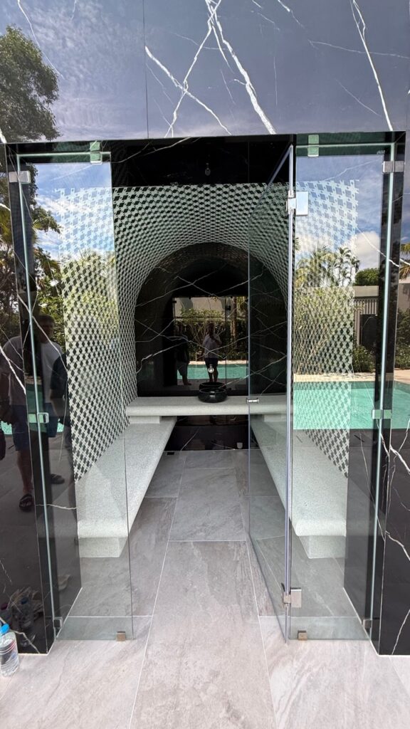 Steam-room seating and glazed entrance at Laguna Homes