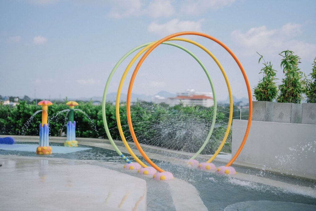 Coloured spray rings and curving PebbleCrete bands at Ocean Marina Resort splash pad