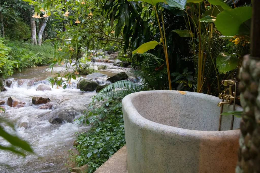 Cool Blue PebbleCrete bath beside a stream and waterfall at Channabot, Chiang Rai