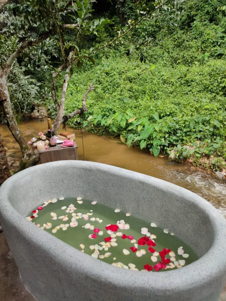 Channabot bath filled with water and flower petals