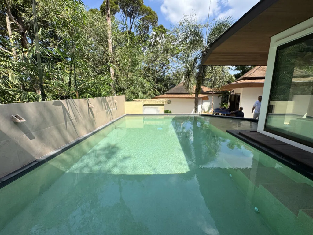 Polar White pool beside a private villa and tropical garden in Phuket