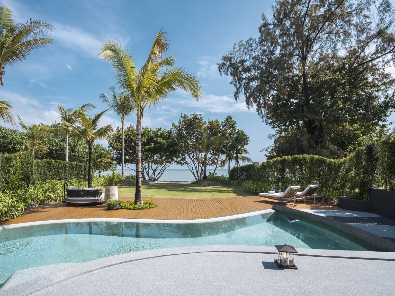 A garden pool opening towards the sea, from the PebbleCrete portfolio