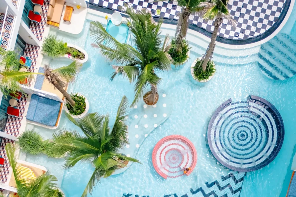 Top-down view of sunlit water, palms and circular platforms at Sugar Marina POP - Kata Beach