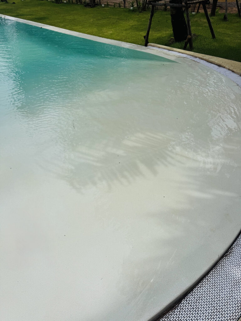 Close view of the broad Pearl White shallow entrance at The Talay, with ripples across the underwater finish.