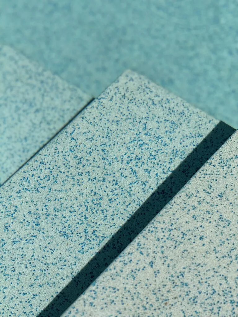Close-up of the blue aggregate finish on submerged pool steps at Villa Tantawan