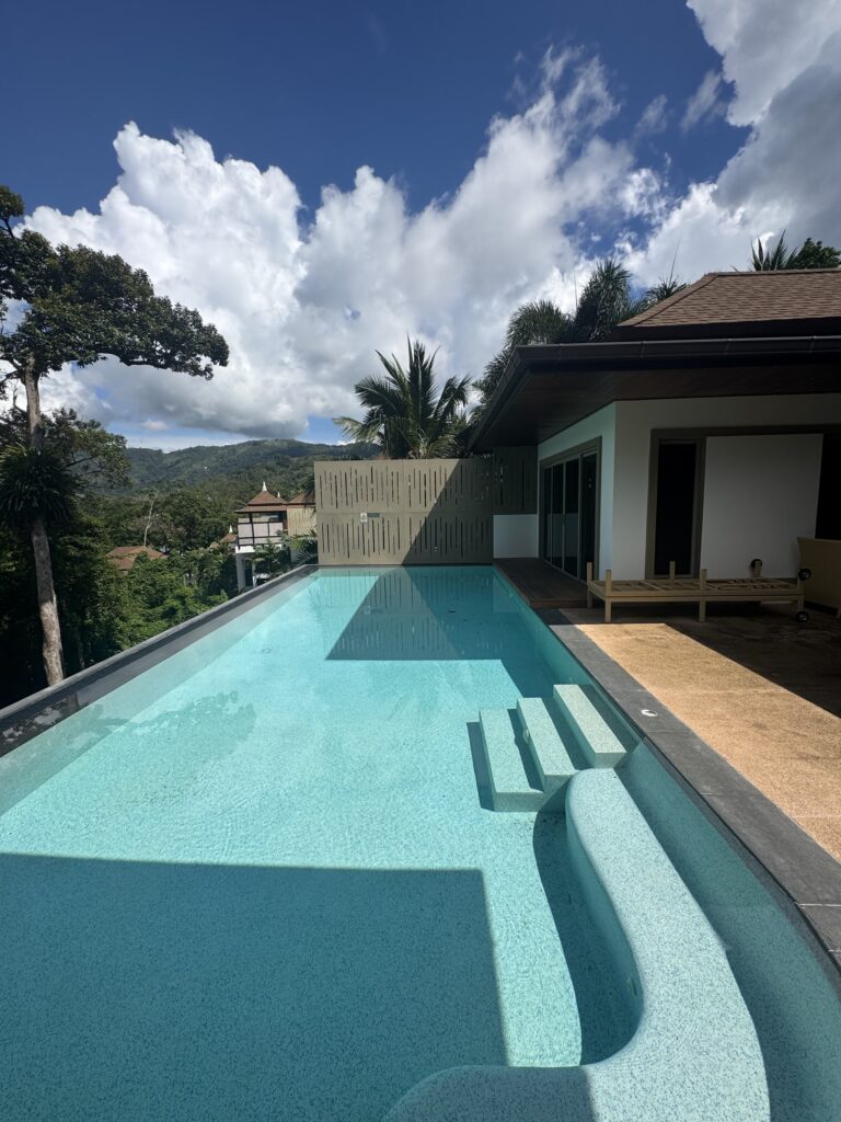 Pool beside the villa with steps and curved seating at Villa Tantawan